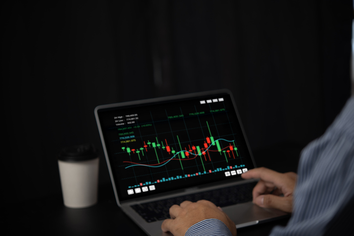 Man using laptop computer graph stock market online analysis finance investment trading forex exchange chart.
