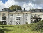 Revealed: What's really happening at luxury hotel where Jacob Rees-Mogg went viral peering over the wall 'to investigate migrants'